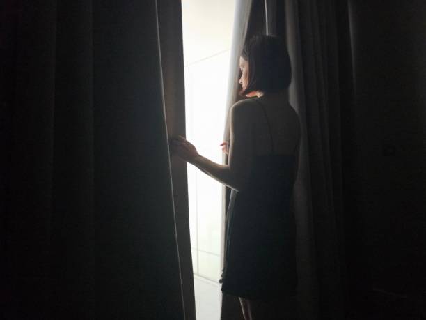 istock Girl opens the curtains concept 2097838074