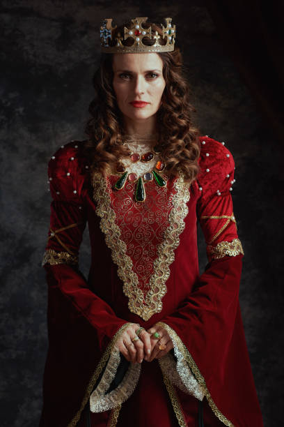 istock medieval queen in red dress with crown 2097852711