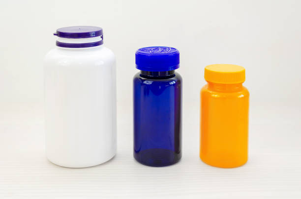 Empty colored plastic bottles for vitamins or medicines on a white background.
