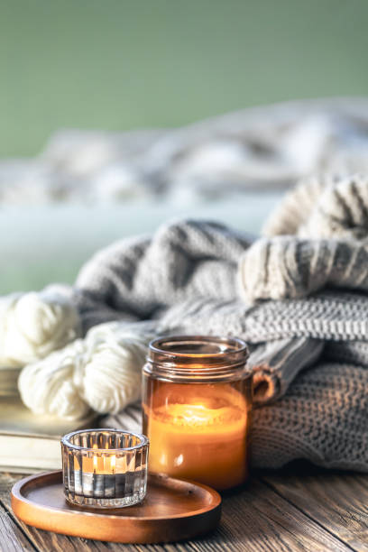 istock Home composition with burning candles, knitted elements and books. 2097857221
