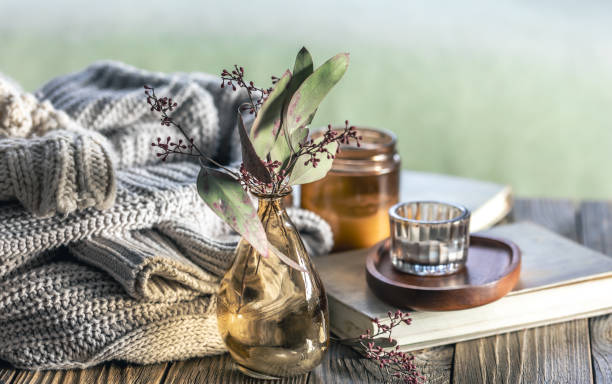 istock Home composition with candles, knitted elements and books on a wooden surface. 2097857224