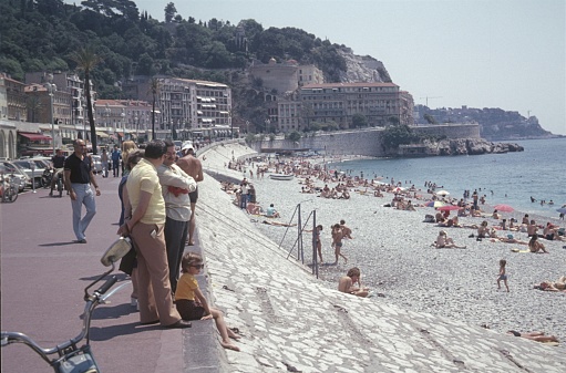 Nice, Cote d'Azur, southern France, 1974. The famous Nice beach with its promenade. Furthermore: locals, holidaymakers and bathers.