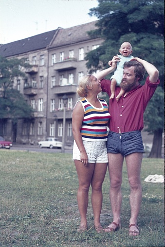 Kreuzberg, Berlin (West), Germany, 1970. Young family on a meadow in a city park.