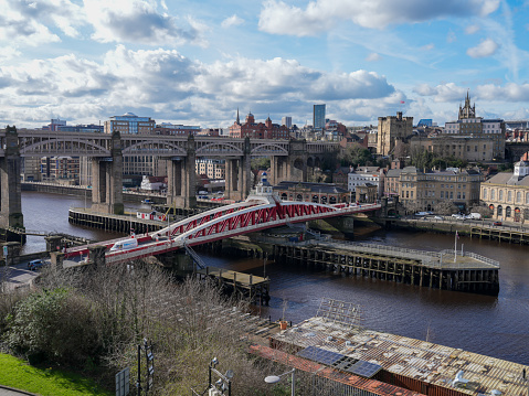 View from the Tyne Bridge looking across at Newcastle's High Level Bridge, used for trains over the River Tyne in Newcastle. The lower bridge is the hydraulic Swing Bridge. The bridges connect the north of England city of Newcastle Upon Tyne with Gateshead. The historic district of the city around the Quayside can be seen on the other side of the river.