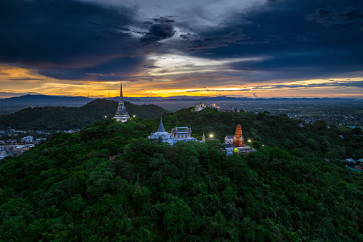 Aerial view by drone during twilight over Phra Nakhon Khiri Historical Park It is decorated with beautiful lights, commonly known as Khao Wang. summer palace, Mueang Phetchaburi District, Phetchaburi.