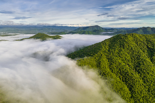 Beautiful flowing fog and clouds above the mountain. A stunning aerial view of the morning fog over the mountains. Nong Ya Plong in Phetchaburi, Thailand.