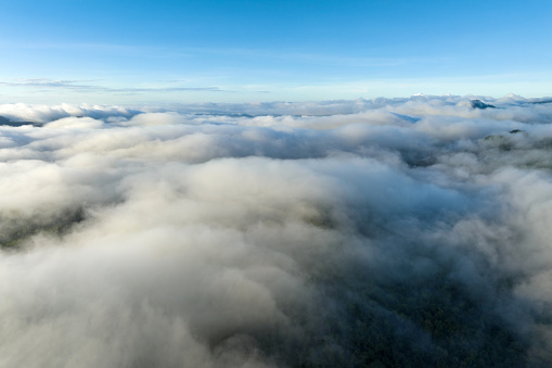 Cloudscape over mountains, aerial view, beautiful scenery in the morning, with a sea of mist moving over the high mountain forests.
