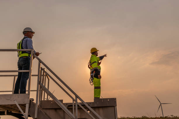 istock Engineer surveyor and manager wearing uniform walking holding box inspection and tablet work in wind turbine farms rotation to electricity, alternative renewable energy for clean power energy concept. 2097978531