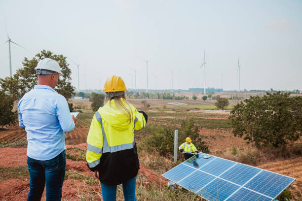 istock Engineers working inspect and check solar cell panel energy is smart grid ecology energy sunlight alternative power with wind turbine farms rotation to generate electricity. 2097979052