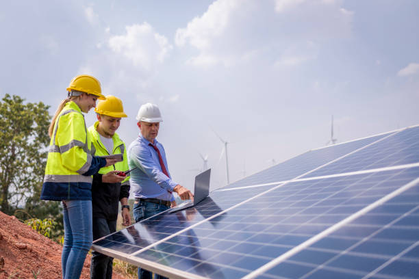 istock Engineers working inspect and check solar cell panel energy is smart grid ecology energy sunlight alternative power with wind turbine farms rotation to generate electricity. 2097979574