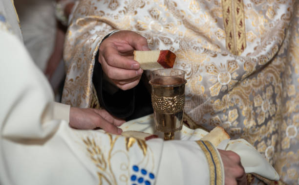 istock consecrated bread into the consecrated wine  in Romania 2097980619