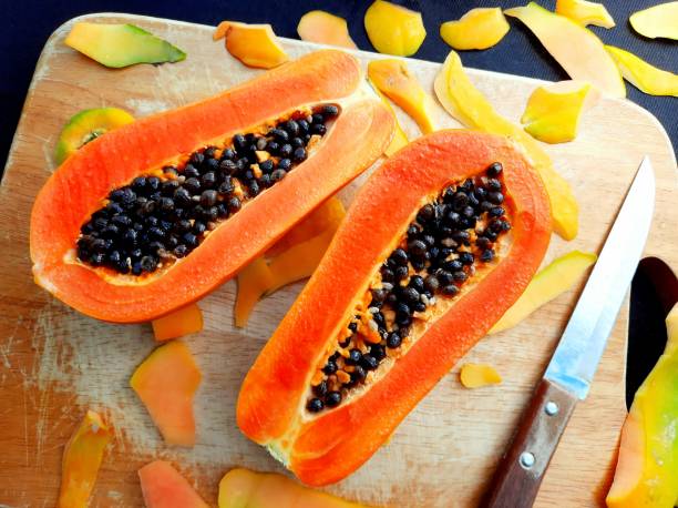 istock Peeling and Cutting Papaya Fruit on cutting board. 2097984714