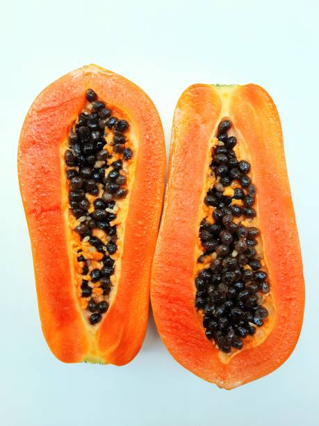 Peeling and Cutting Papaya Fruit - white background.