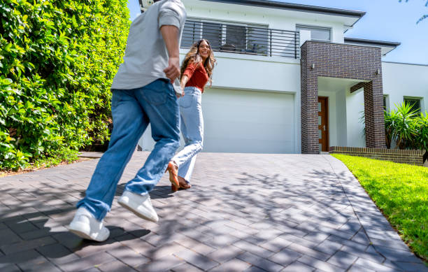 istock Couple joyfully running into their new home. 2098018309