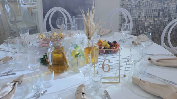 istock Elegant table setting in a luxurious restaurant. Luxurious banquet tables prepared for the official ceremony. A round table without food is served with plates, napkins, glasses and cutlery. 2098050846