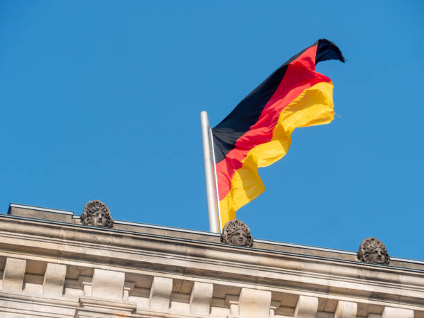 istock German Flag Waving Against Clear Blue Sky 2098079677