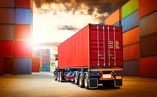 Semi trailer Trucks and Containers Cargo Shipping. Handling of Logistics Transportation Industry. Cargo Container ships, Freight Truck Import-Export. Distribution Warehouse. Logistics Truck Transport.