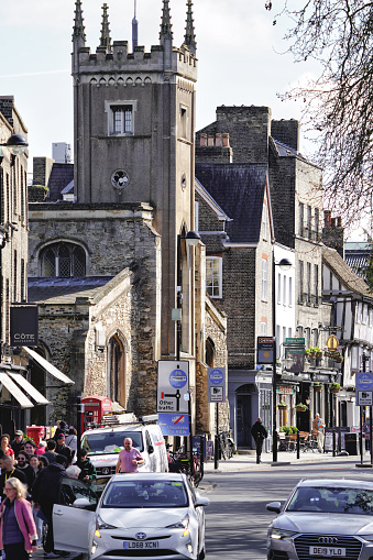 Bridge Street, Central Cambridge, Cambridgeshire, England, United Kingdom, Great Britain, Europe. March 18, 2024. Parish Church of St Clement Tower (A Church - An Anglican church) and St Ephraim Orthodox Parish (A Russian Orthodox church) in Bridge St, Cambridge CB2 1UF, United Kingdom.

The photo captures a street view in an urban environment in Britain, with pedestrians walking along the road. The cityscape showcases distinctive British buildings. It was taken on the Magdalene Bridge located at Bridge St (It runs between Magdalene Street at the junction with Thompson's Lane to the northwest and Sidney Street at the junction with Jesus Lane to the southeast), in Cambridge CB2 1UJ, United Kingdom.