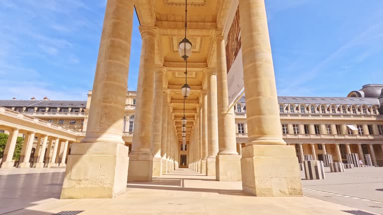 Majestic colonnade of Palais Royal under clear blue skies in Paris, France