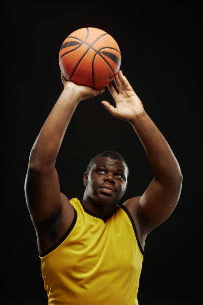 istock Black Basketball Player Passing Ball 2098154355