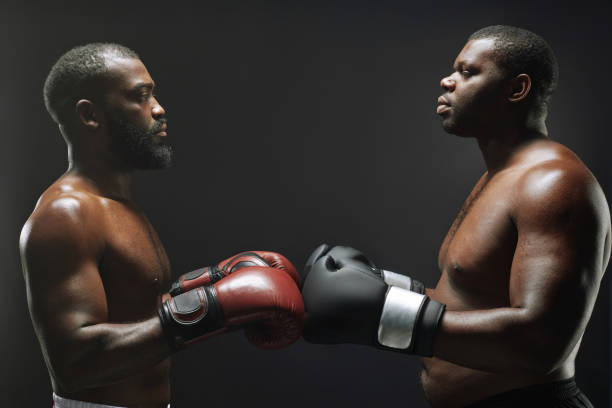 istock Two Black fighters bumping boxing gloves 2098154932