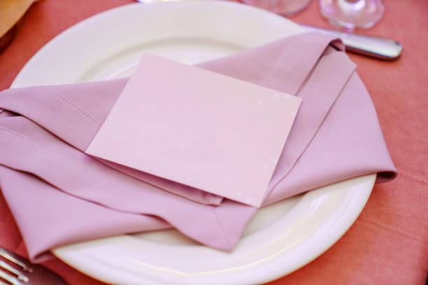 Table setting. A plate with purple napkins and a seating card. Place for the inscription.