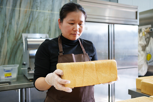 Baker holding toast brick
