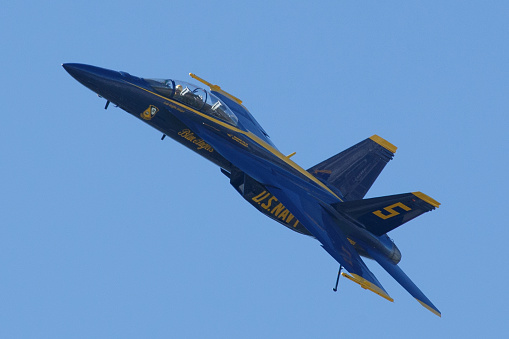 Suisun City, Ca. / USA - March 17, 2024: A Blue Angel fighter jet flies over  a Suisun City neighborhood while performing during the \