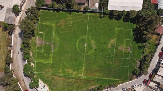 Hyperlapse of a soccer field, players move together. Aerial view