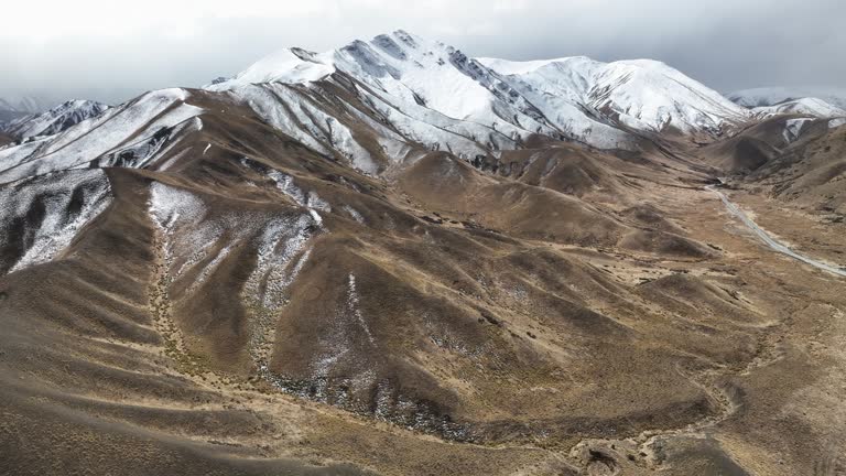 Isolated mountains in Lindis Pass with highway, New Zealand.