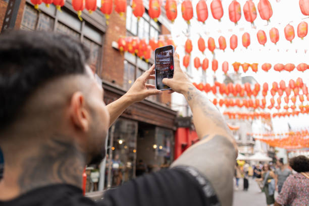 istock Tourist Capturing Colorful Lanterns on Smartphone 2098275218