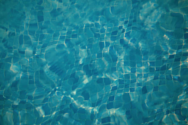 sun reflection in a blue tile in a swimming pool