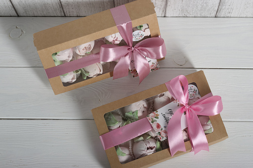 Marshmallows in a gift box with a transparent lid. The box is tied with a ribbon. The inscriptions are 