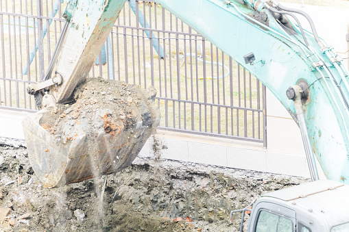 Excavator digs soil