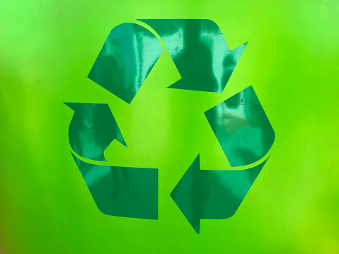 Green recycle symbol on cardboard