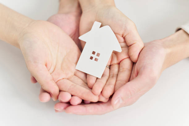 istock Hands of a man and woman carrying household objects 2098380672