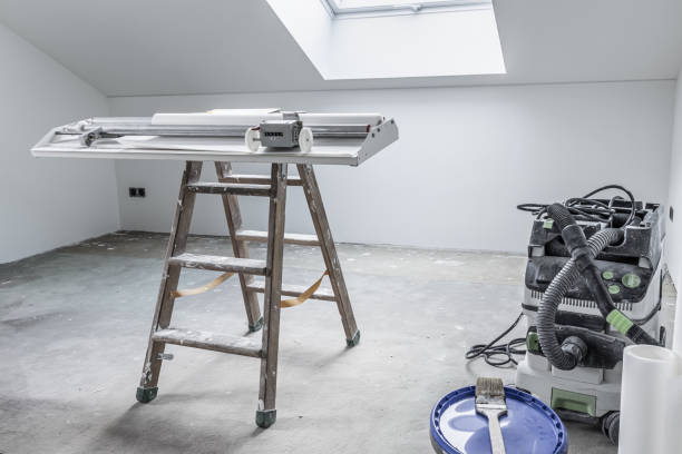 istock Home renovation - empty room with pasting table for cutting wallpaper and tools 2098385015