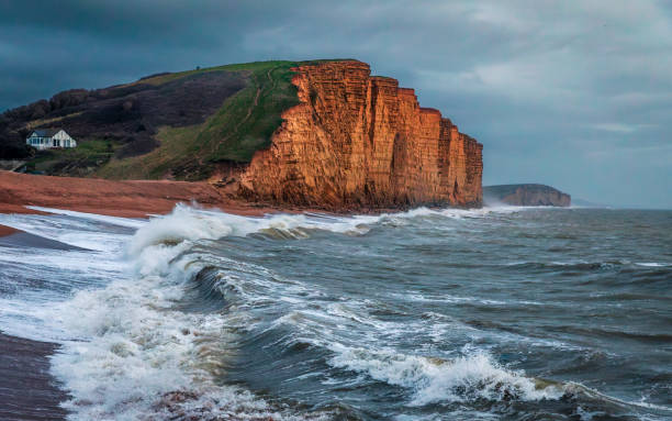 The dramatic sandstone east cliff and Jurassic coast from West Bay on the Dorset coast south west England UK