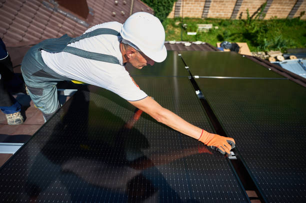 istock Workers building solar panel system on roof of house. Men installing photovoltaic solar module 2098422480