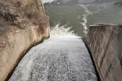 Water release from a sluice on a dam wall closeup