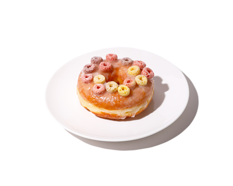 glazed donut with cereal topping on plate