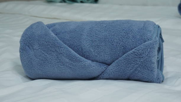 istock luxury hotel quality shower bath room small exercise face towel in roll shape size on bed product photo shoot display in blue white brown color catalog background menu 2098455133