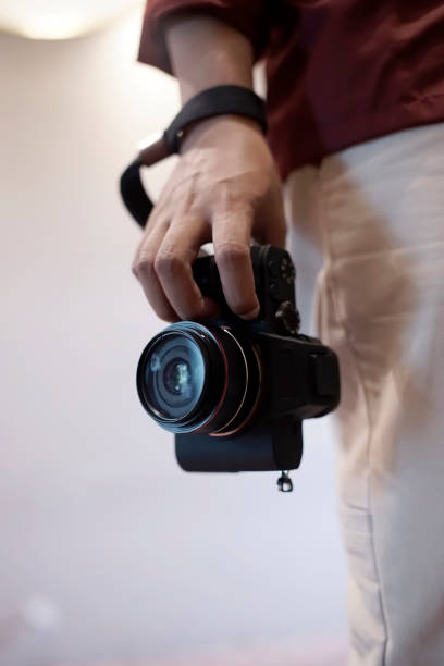 istock close up photographer holding camera with right hand 2098457259