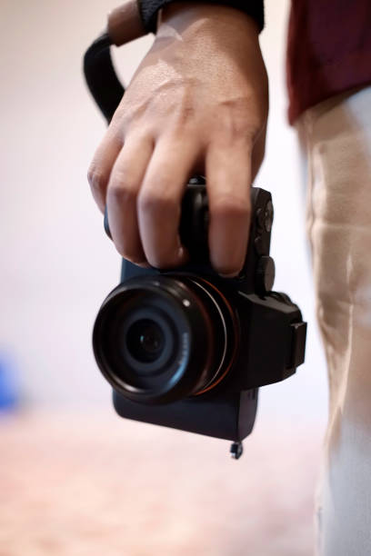 istock photographer holding camera with right hand 2098458286