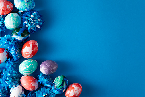 Colorful dyed easter eggs on blue background