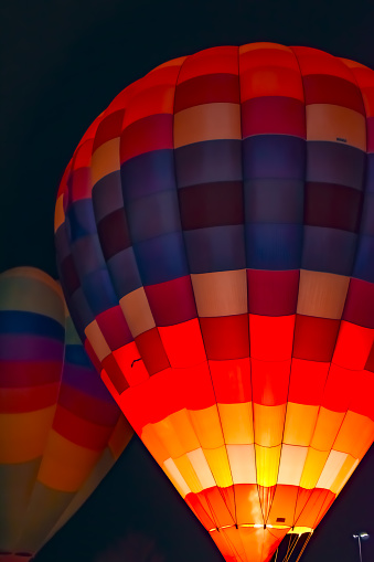 A glowing hot air balloon at night.