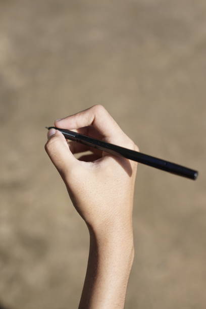 istock the concept of education by holding a pen 2098495042