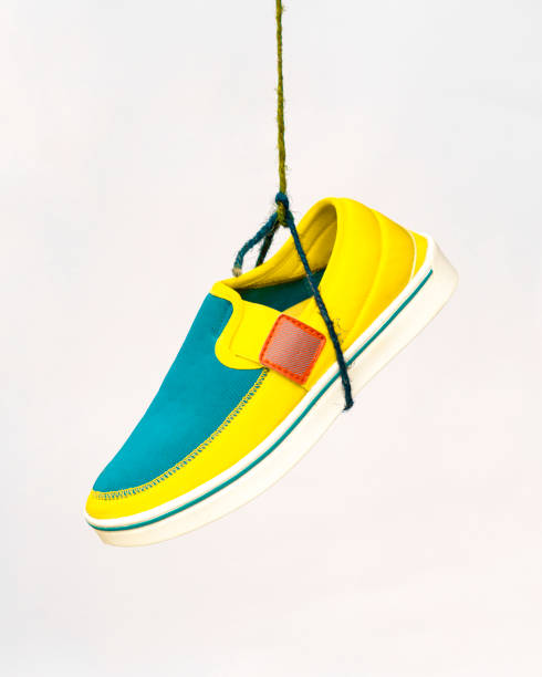Yellow and blue walking sneaker with white background.\nElevate your visual projects with this high-quality image, perfect for fashion blogs, advertisements, and social media posts.