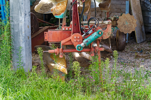 Scenic view of agriculture equipment at shelter at village of Zabnica on a blue cloudy summer evening. Photo taken August 10th, 2023, Zabnica, Kranj, Slovenia.