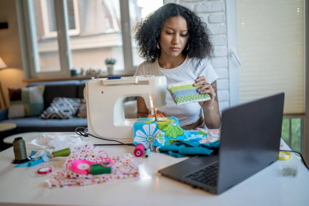istock A freelance woman sitting at home sewing on a machine 2098544059